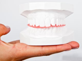 Man holding a teeth sample for visuals social media.jpeg