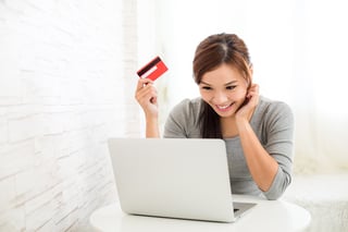 Woman enjoy online shopping paying by credit card.jpeg