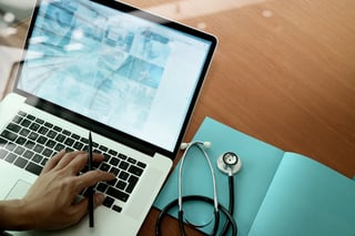 top view of Medicine doctor hand working with modern computer and smart phone on wooden desk inbound marketing email .jpeg